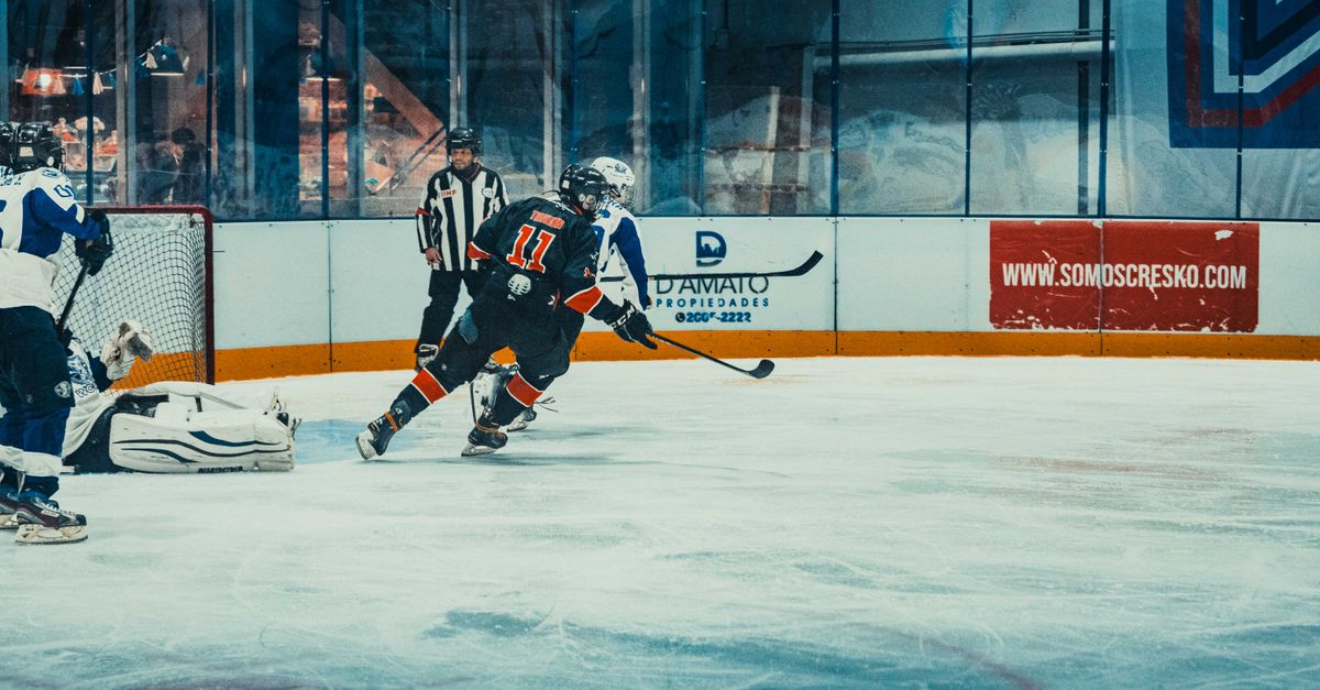 Exciting ice hockey scene capturing a high-energy match in Buenos Aires with players and referee in action.